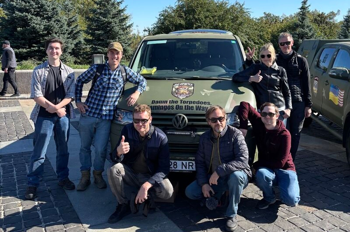 Volunteers with a delivered pickup truck on the cobbled square in Lviv